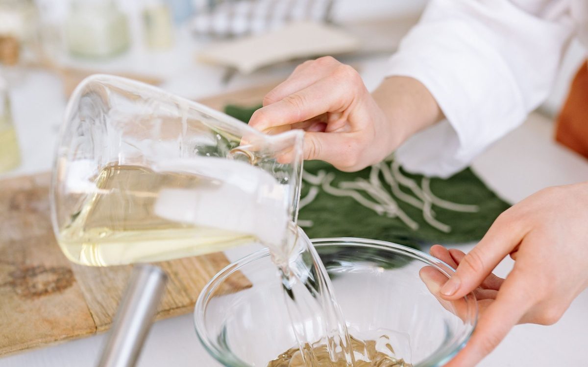 Clear liquid being poured into a glass bowl