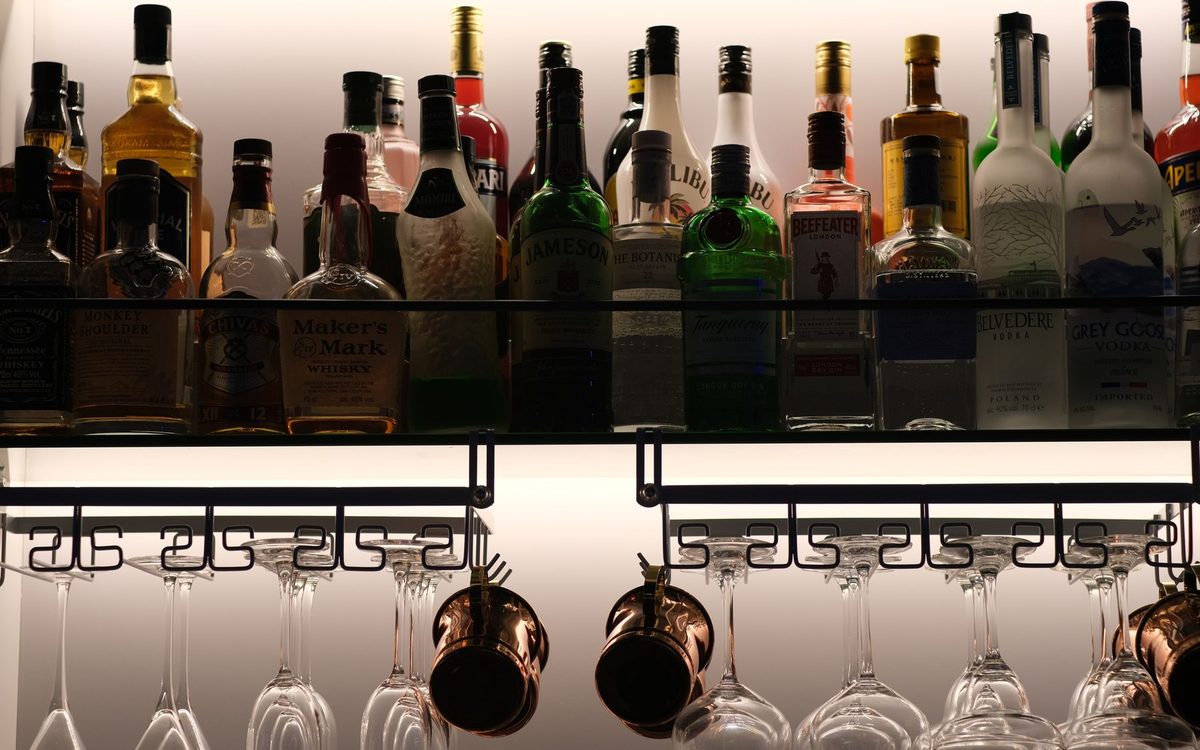Home bar shelf with bottles and glasses
