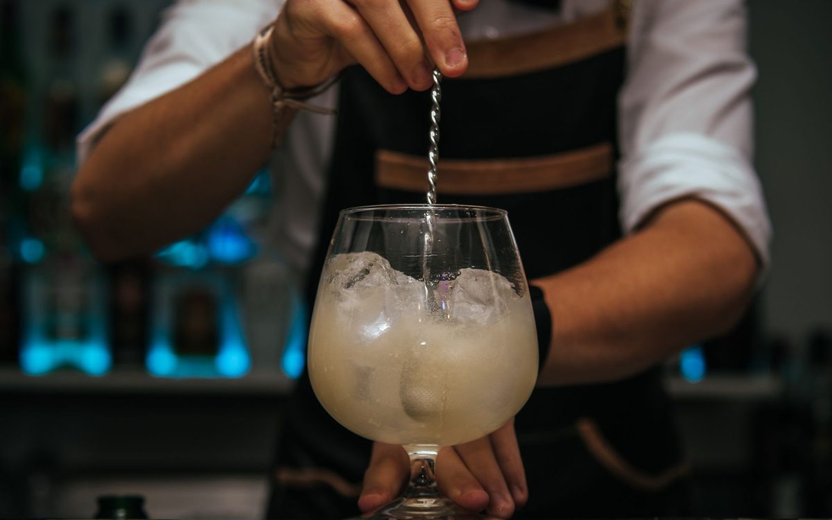 Bartender garnishing a cocktail