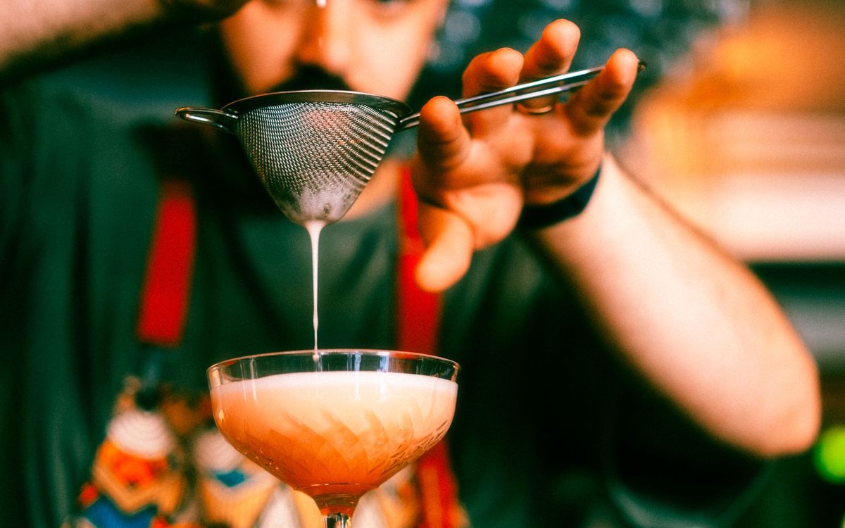 Cocktails being prepared on a bar counter