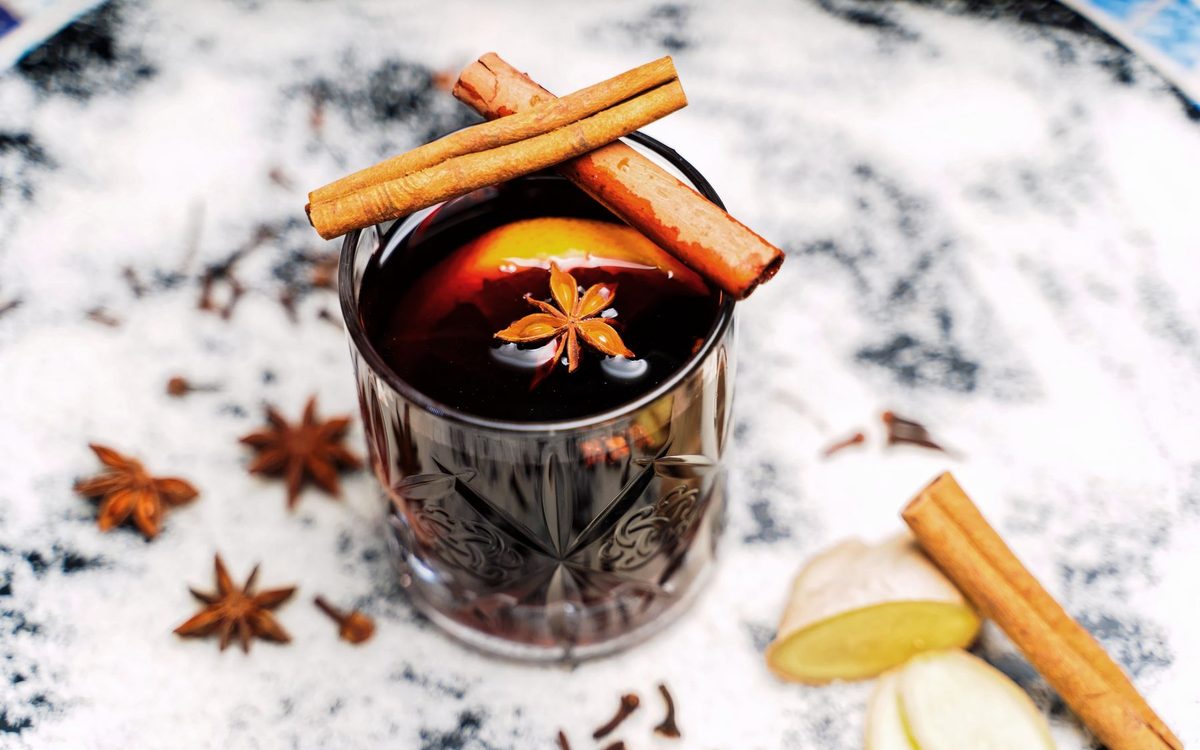 A spiced drink with cinnamon sticks and star anise