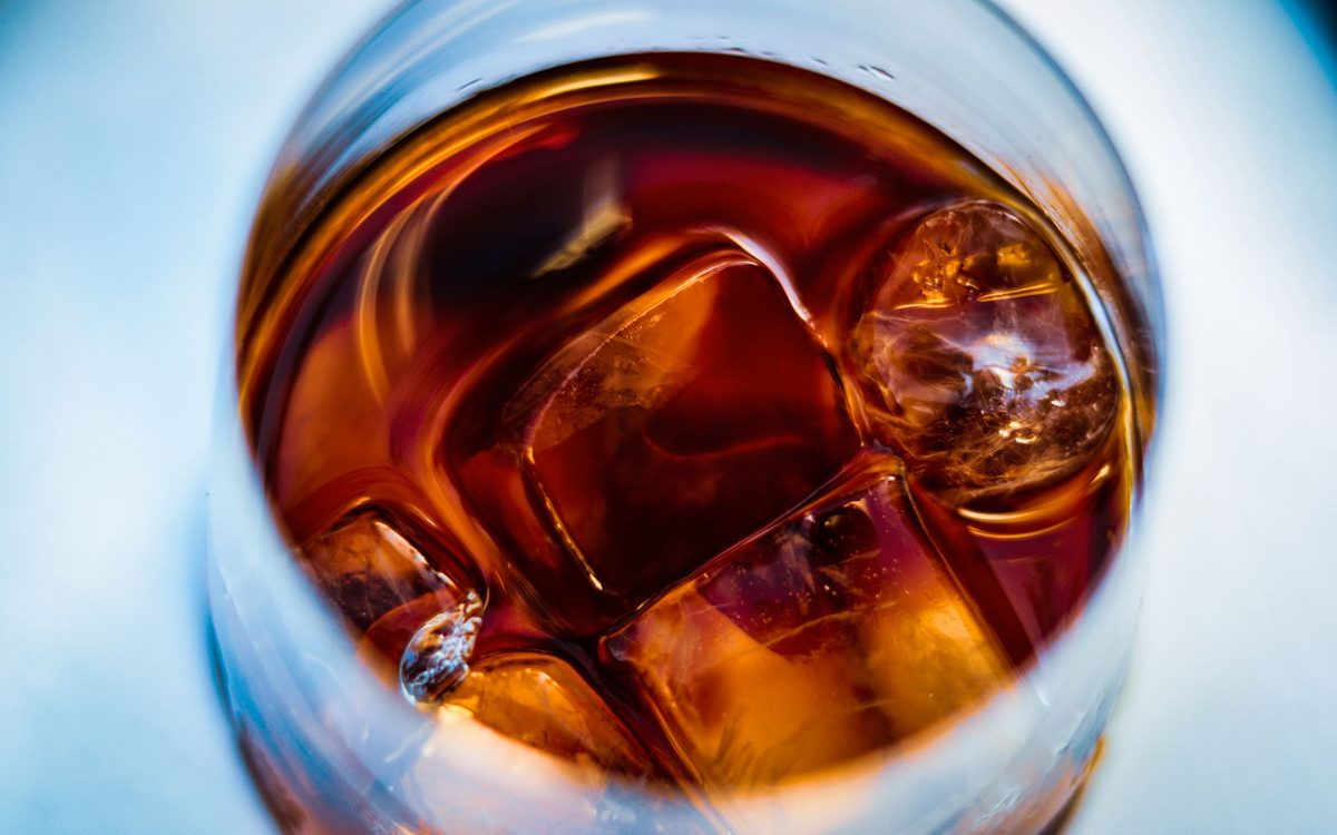 Amber stirred cocktail over ice seen from above
